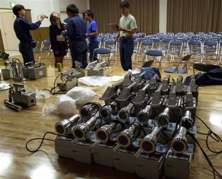 Radiation detection devices are prepared after a 1997 radiation leak at a uranium processing facility in Tokaimura, 70 miles northeast of Tokyo. Behind Japan’s escalating nuclear crisis sits a scandal-ridden energy industry in a comfy relationship with government regulators.